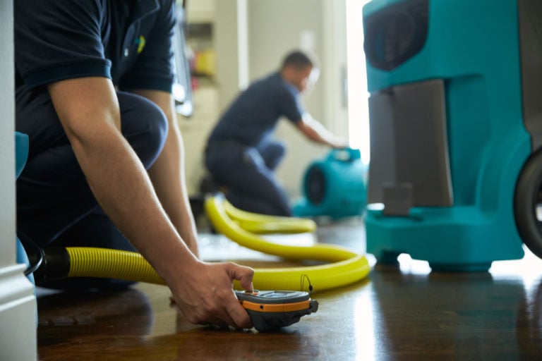Close-up of restoration equipment at floor level during water damage cleanup